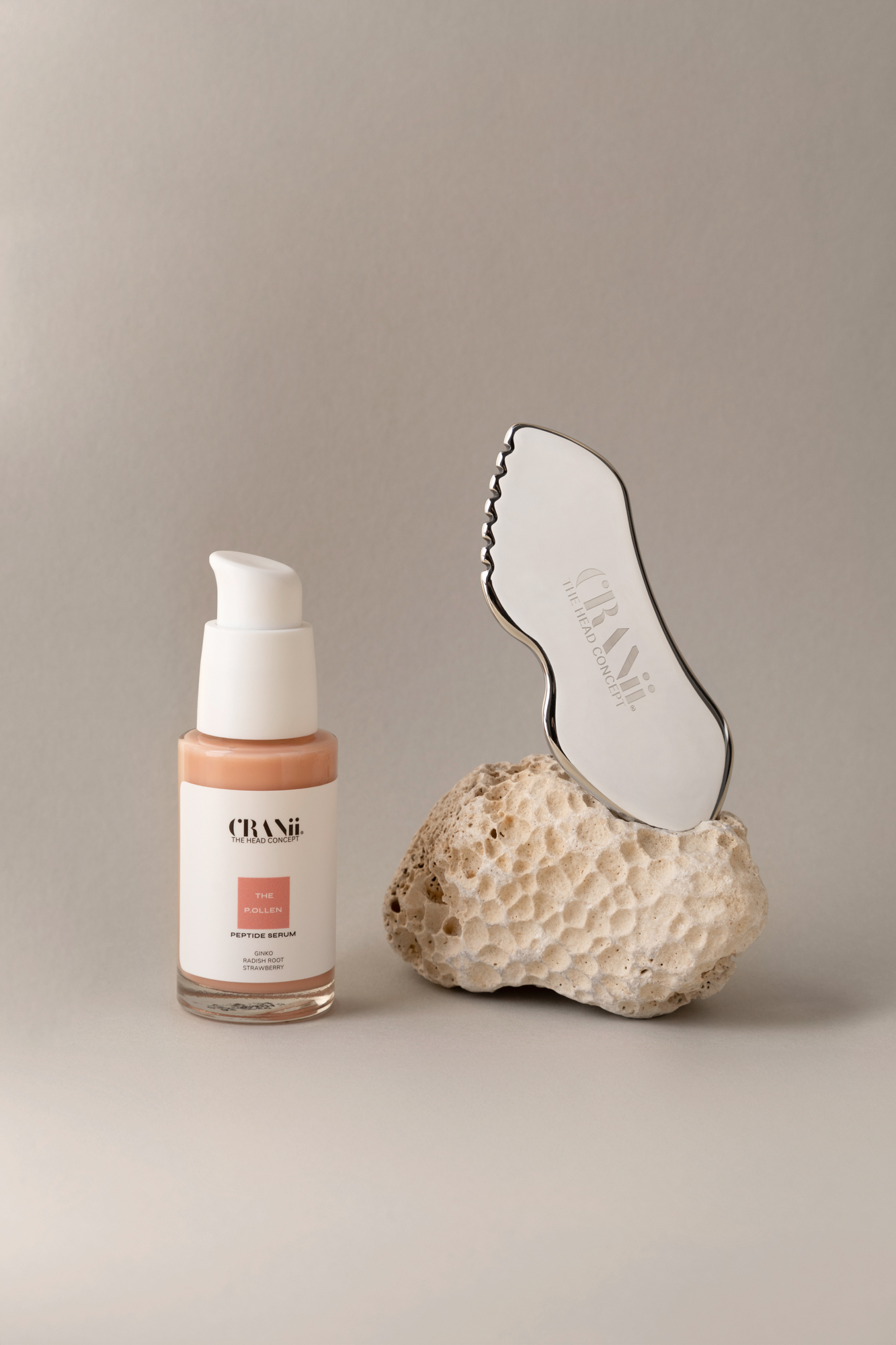 Studio product photo featuring CRANii skincare items and beauty tools in a minimal composition.